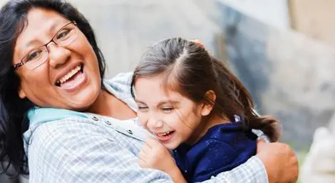 foster-mother-hugging-laughing-smiling-with-young-female-foster-child