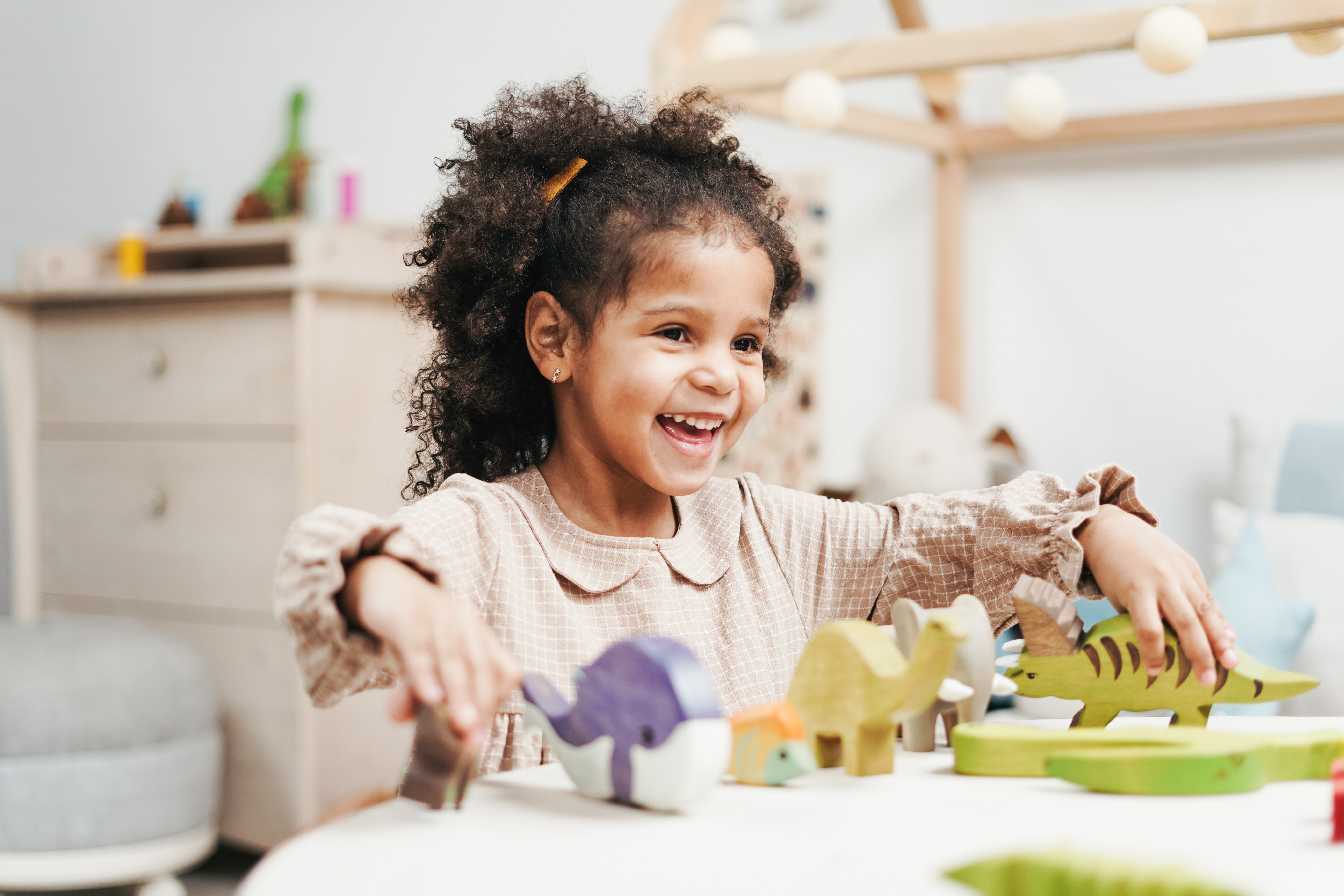 happy-girl-playing-with-dinosaurs