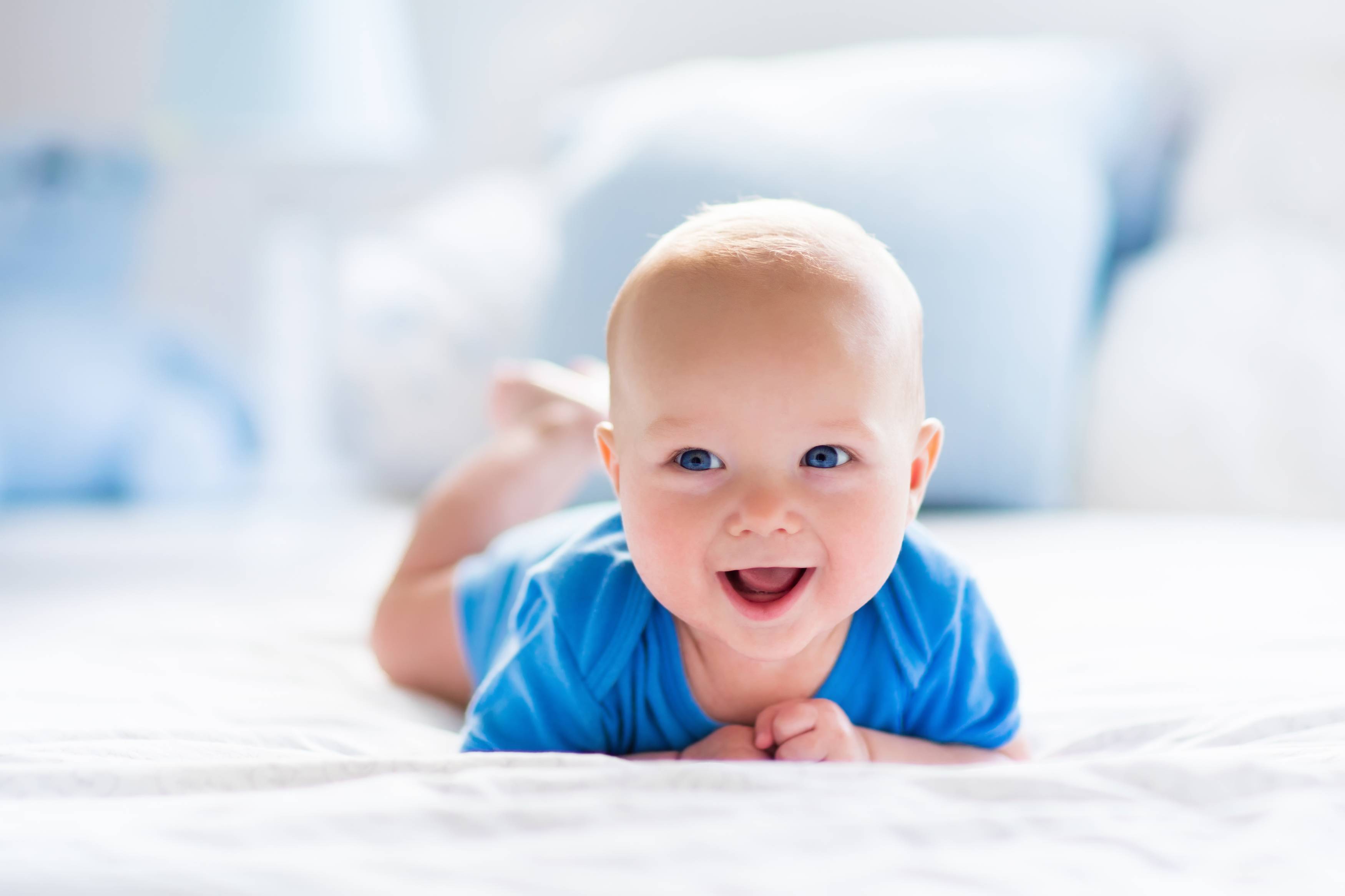 happy-smiling-baby-in-blue-clothes
